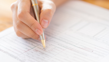 21236176 Hand With Pen Over Application Form