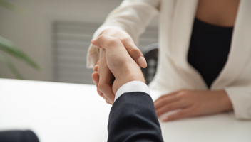 Mp25836461 Female Worker Greeting Business Partner With Handshake