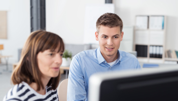 13077060 Business People Reading Something On Computer