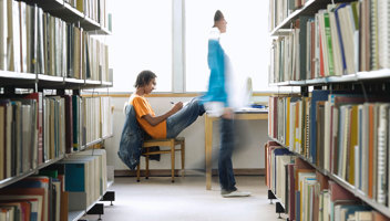 18805084 College Student Doing Homework In Library