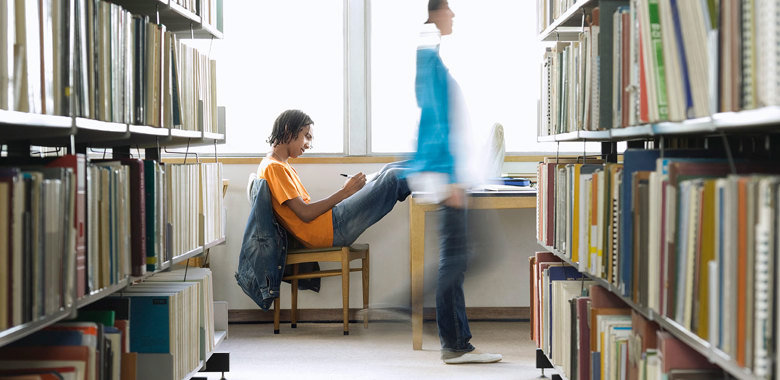 18805084 College Student Doing Homework In Library
