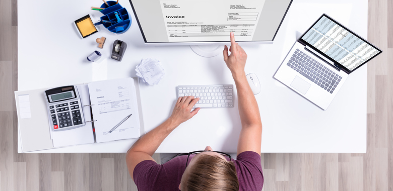 32616673 Businessman Checking Invoice On Laptop